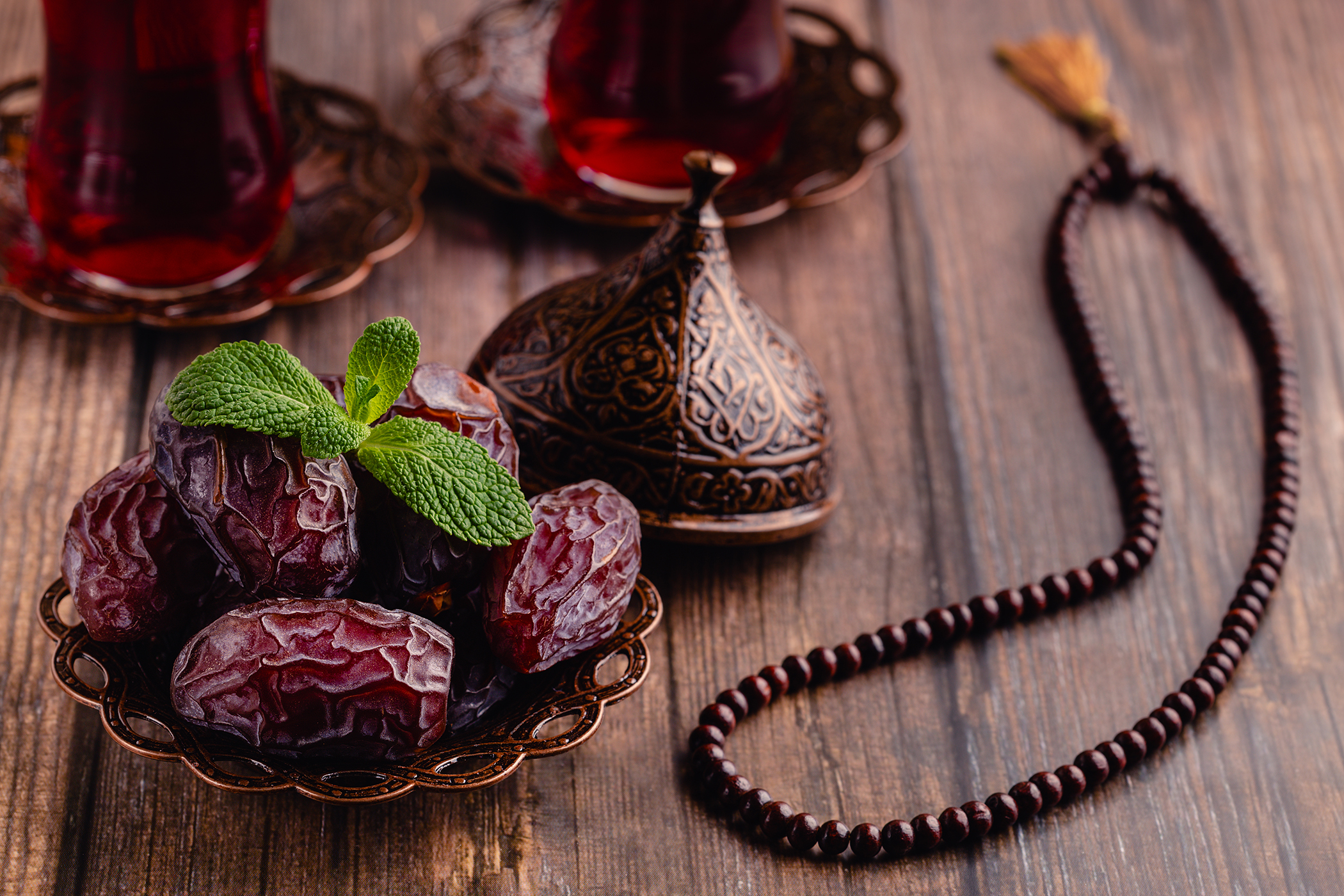 Dried dates fruit, tea and rosary. Popular fruit of Ramadan.